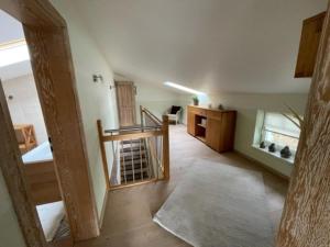 an attic hallway with a staircase and a room at Villa Seestern - Ferienhaus mit Meerblick in Sassnitz
