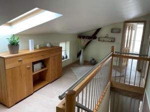 a living room with a staircase and a skylight at Villa Seestern - Ferienhaus mit Meerblick in Sassnitz