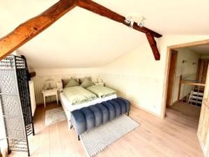 a bedroom with a bed in a attic at Villa Seestern - Ferienhaus mit Meerblick in Sassnitz +5 photos
