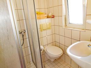 a small bathroom with a toilet and a sink at Ferienzimmer zum Försterberg in Hagen