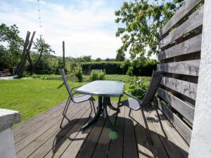 a table and two chairs sitting on a deck at Ferienzimmer zum Försterberg in Hagen