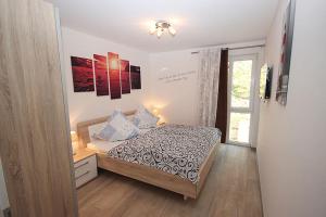 a small bedroom with a bed and a window at Villa Amelie FeWo Seemoewe in Sassnitz