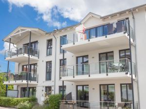 an apartment building with balconies and an american flag at Villa Amelie FeWo Seemoewe in Sassnitz