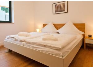 a white bed with two pillows on top of it at Villa Friede Marie FeWo Hannah in Sassnitz