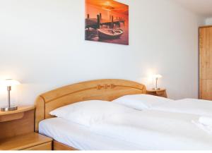 a bedroom with two beds and a picture of a boat at Villa Friede-Marie, FeWo Meeresidyll in Sassnitz +6 photos