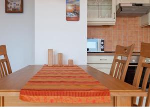 a kitchen with a wooden table with a colorful blanket on it at Villa Friede-Marie, FeWo Meeresidyll in Sassnitz