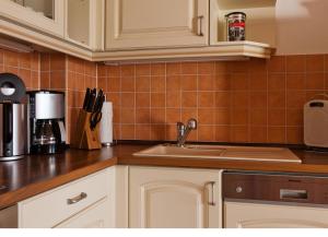 a kitchen with a sink and a counter top at Villa Friede-Marie, FeWo Meeresidyll in Sassnitz