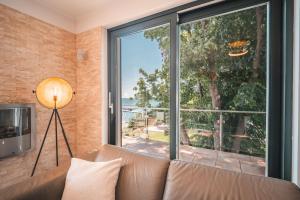 a living room with a couch and a large window at Villa Friede Marie FeWo Ostseeweitblick in Sassnitz