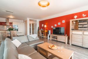 a living room with a couch and a table at Villa Friede Marie FeWo Ostseeweitblick in Sassnitz