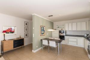a kitchen with a table and chairs in a room at Villa Friede Marie FeWo Svea in Sassnitz