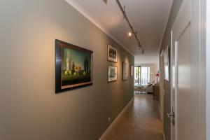 a hallway with a painting of apples on the wall at Villa Friede Marie FeWo Svea in Sassnitz +4 photos