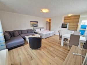 a living room with a couch and a table at Villa Monika Backbord 2 in Sassnitz
