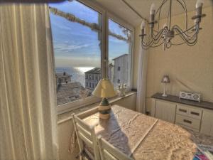 a room with a table and a large window at Villa Seeblick - Apartment 309 in Sassnitz