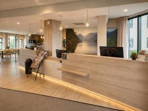 a lobby of an office with a reception counter at Haukeland Hotell in Bergen