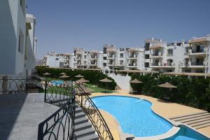 a view of a swimming pool with some buildings at Sharm Hills Elite Suite in Sharm El Sheikh