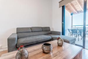 a living room with a couch and a table at Beachside Hideaway Apartment, 200m to the Havana Beach in Pyla