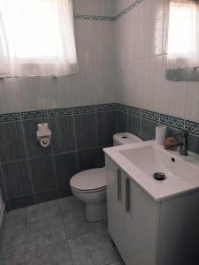 a bathroom with a toilet and a sink at La Mar in Los Realejos +25 photos