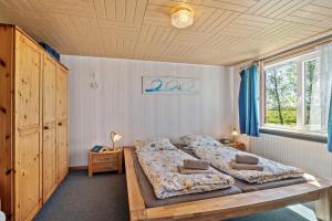 a bedroom with two beds and a wooden ceiling at Ferienhof Knudsen in Pellworm