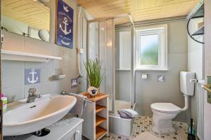 a bathroom with a sink and a toilet at Ferienhof Knudsen in Pellworm +39 photos