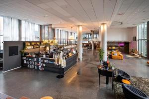a lobby of a store with tables and chairs at Comfort Hotel Union Brygge in Drammen
