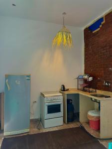 a kitchen with a stove and a counter and a refrigerator at Studio In DaHaB in Dahab