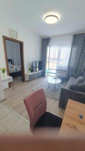 a living room with a couch and a table at Aqua Lux Apartman in Jagodina