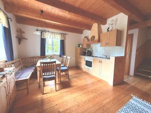 a kitchen and dining room with a table and chairs at Stefflhof in Gabersdorf +26 photos