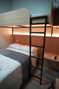 Ein Zimmer mit Etagenbetten, zwei Etagenbetten und einer Leiter in der Unterkunft Hotel Pandolfi in Dois Vizinhos