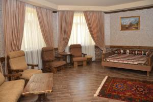 a living room with a bed and a couch and chairs at Senger Qala Riverside in Qax