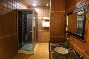 a bathroom with a shower and a sink and a mirror at Senger Qala Riverside in Qax