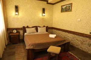 a bedroom with a bed and a clock on the wall at Senger Qala Riverside in Qax +48 photos