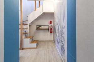 a staircase in a house with blue walls at NURAS - Affittacamere L'Azzurra - Double bedrooms private bathroom and seaview solarium in Sorso