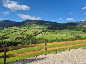 a wooden fence with a view of a green valley at Sommerkino in Krispl