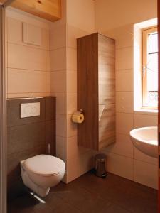 a bathroom with a toilet and a sink at Haus "Charly" in Nauders +5 photos