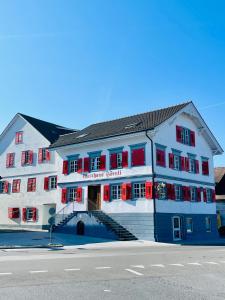 a blue and white building with red windows and stairs at Appartement "Loft Seeliebe" in Kreuzlingen