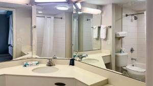 a bathroom with a sink and a toilet and a mirror at Motel 6 Aurora, CO - Medical Center in Aurora