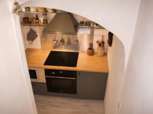 a kitchen with a stove and a stove top oven at Volca'séjour in Orcines +1 photo