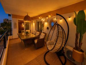 a living room with a table and a chair at Roses Beach in Roses