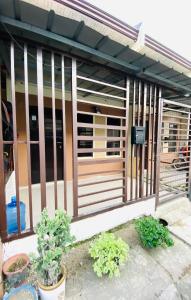 a fence on the side of a building with plants at Sparrow Transient Townhouse in Davao City