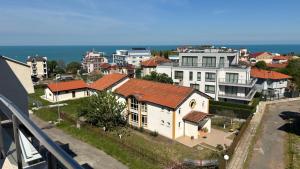 a view of a city with houses and the ocean at Семеен хотел Сирена in Ahtopol