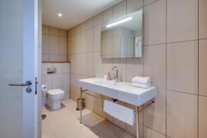 a bathroom with a sink and a toilet at The Suites at Pannells Ash in Castle Hedingham +20 photos