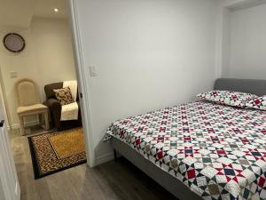 a bedroom with a bed and a chair in it at Mill pond cozy and private 2 in Richmond Hill