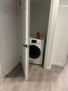 a microwave in a room with a door open at Mill pond cozy and private 2 in Richmond Hill +8 photos
