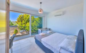 a bedroom with a bed and a large window at Nergiz Villas in Kaş +72 photos