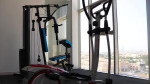 a group of exercise bikes in a room with a window at Terrace Alzahra تيراس الزهرا in Jeddah