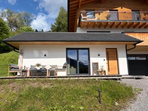 a house with a patio and a balcony at Appartement Bergwild in Bürserberg +23 photos