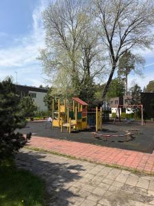 a playground in a parking lot with a yellow playground at The Baltic Sea Hideaway in Narva-Jõesuu