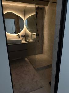 a bathroom with a shower and a sink and a mirror at The Baltic Sea Hideaway in Narva-Jõesuu +24 photos
