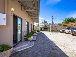 a building with cars parked in a parking lot at Hazeldene Accommodation in Colesberg