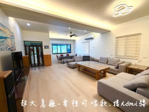 a living room with a couch and a table at 晨溪民宿 in Wujie +7 photos